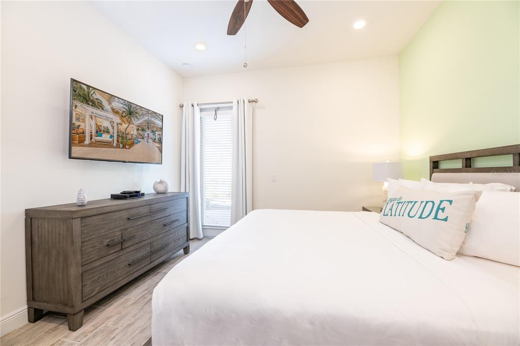 2956 Salted Rim Road Kissimmee, FL 34747 - Photo 8 of 12 a bedroom with a bed and a chandelier