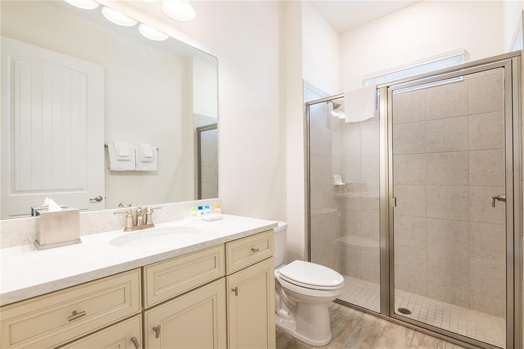 2956 Salted Rim Road Kissimmee, FL 34747 - Photo 9 of 12 a bathroom with a sink a toilet a mirror and shower