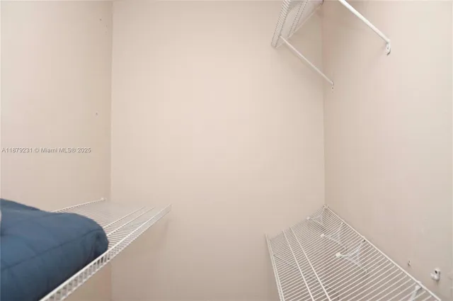 a bathroom with a granite countertop sink and a window