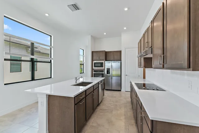 a kitchen with a refrigerator and cabinets