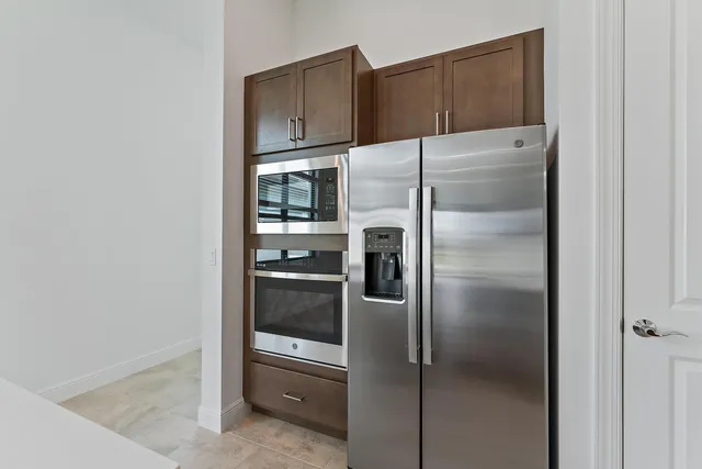 a kitchen with sink cabinets and refrigerator