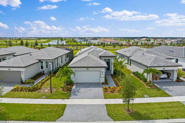 an aerial view of a house with a garden and deck