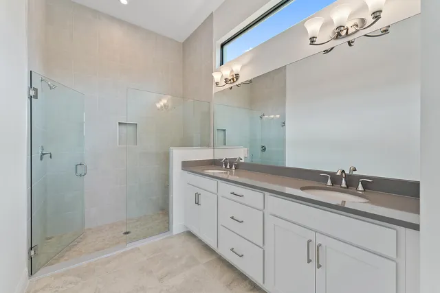 a bathroom with a shower sink and mirror