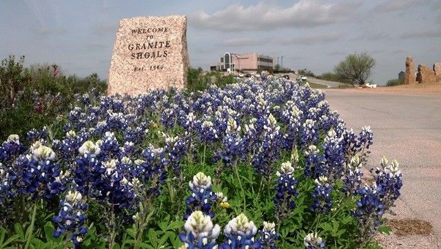 a sign that is in front of flowers
