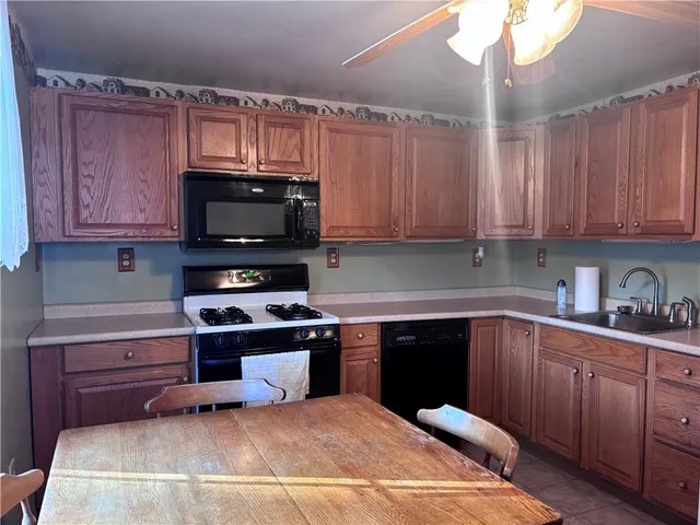 a kitchen with a sink cabinets and stainless steel appliances