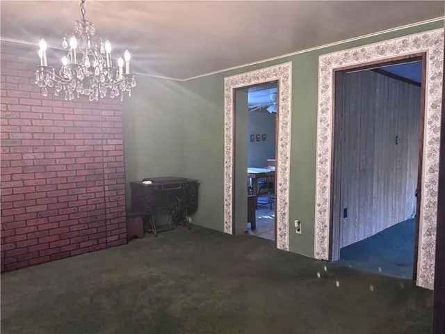 a view of a chandelier in big room and chandelier