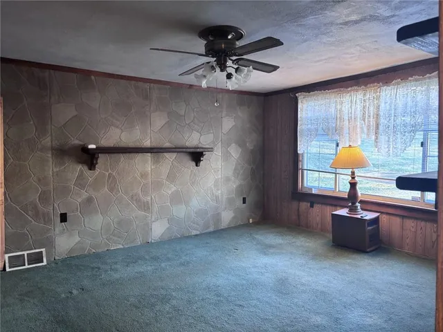 a view of an empty room and a window