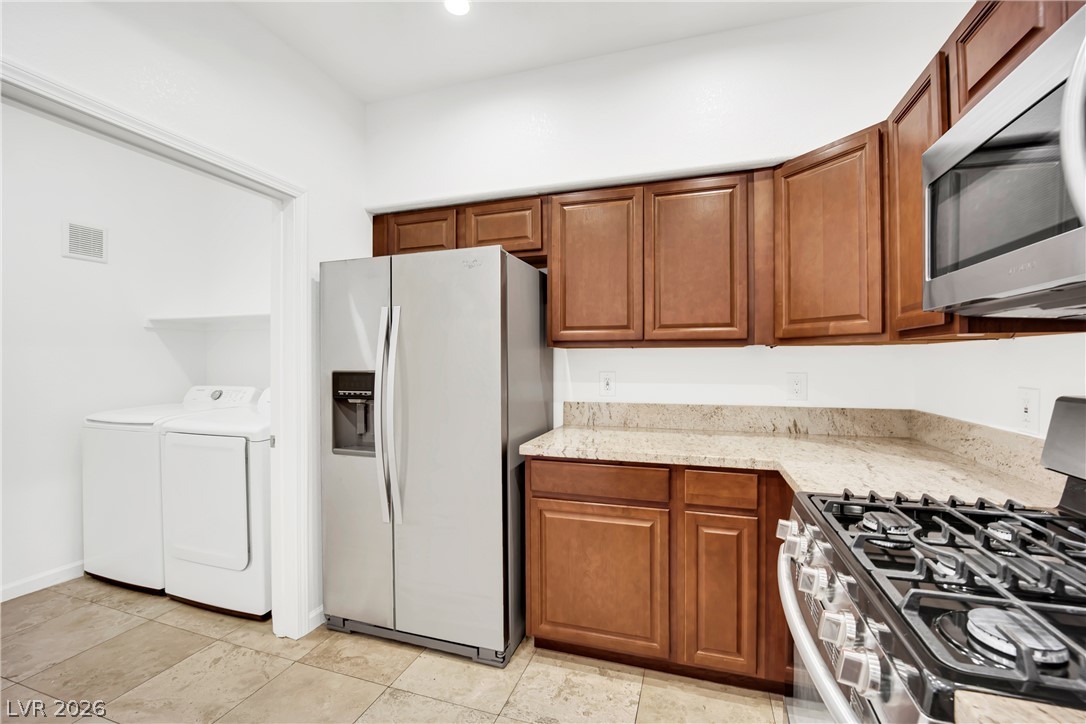 8725 West Flamingo Road, Unit 110 Las Vegas, NV 89147 - Photo 3 of 30 Culinary adventures await with a full suite of modern appliances and polished countertops.
