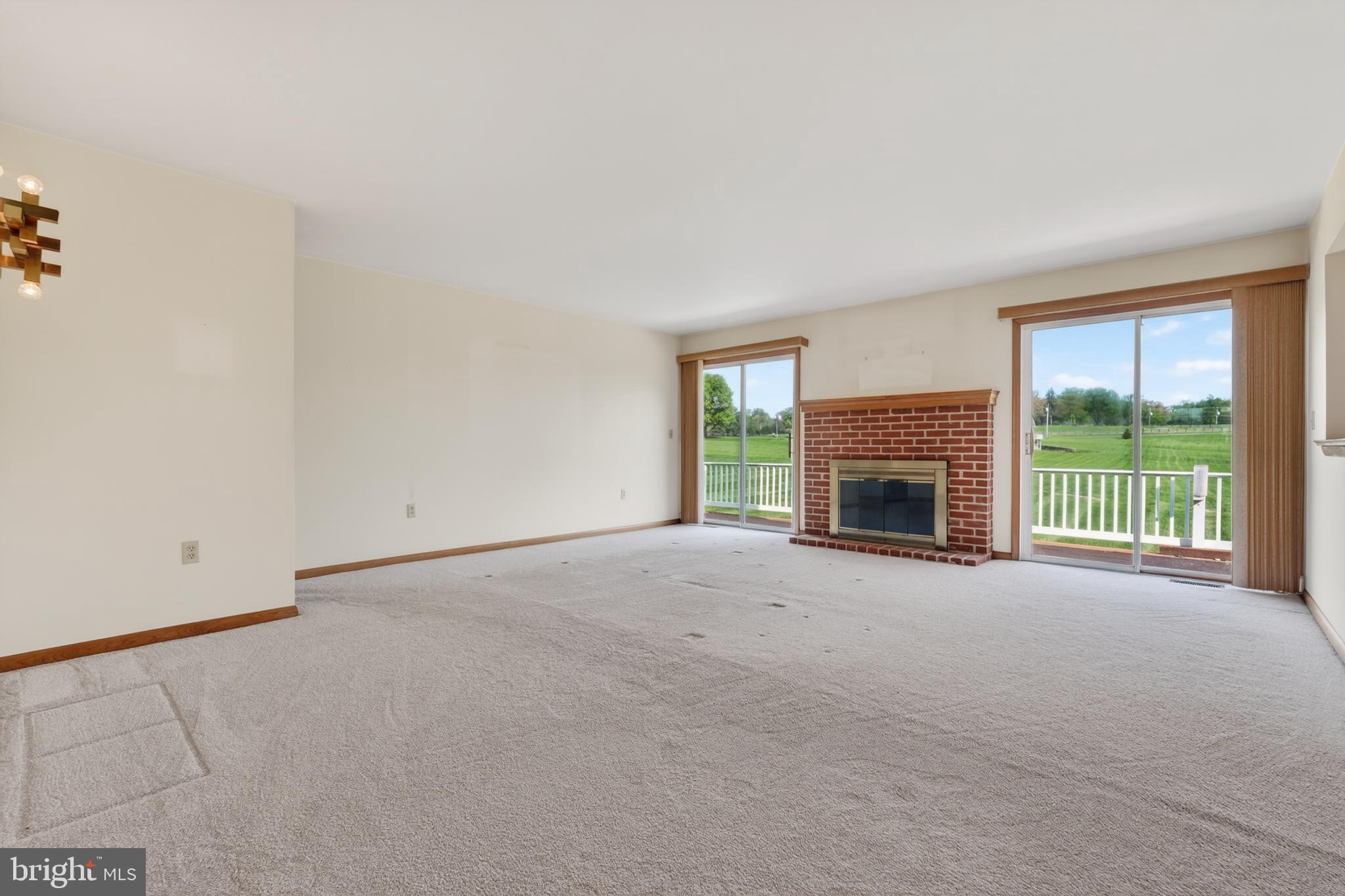 9 Drake Road Chesapeake City, MD 21915 - Photo 11 of 39 an empty room with windows fireplace and a small yard