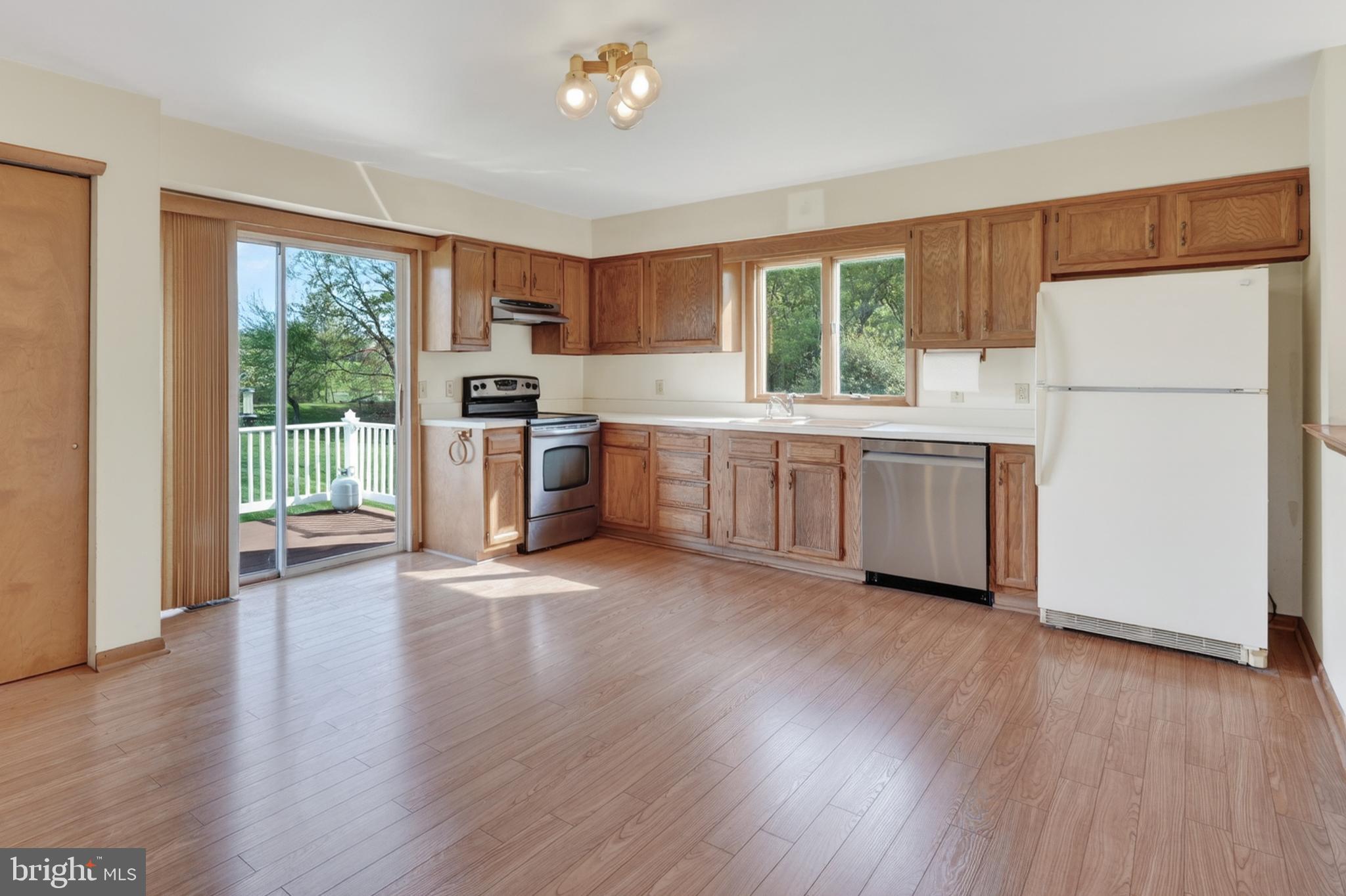 9 Drake Road Chesapeake City, MD 21915 - Photo 3 of 39 a kitchen with wooden floors and white stainless steel appliances