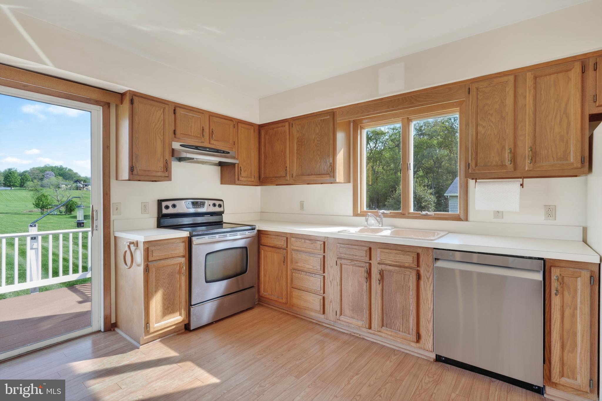 9 Drake Road Chesapeake City, MD 21915 - Photo 4 of 39 a kitchen with white cabinets a sink a window and appliances