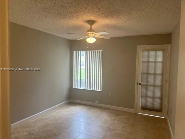 an empty room with closet and windows