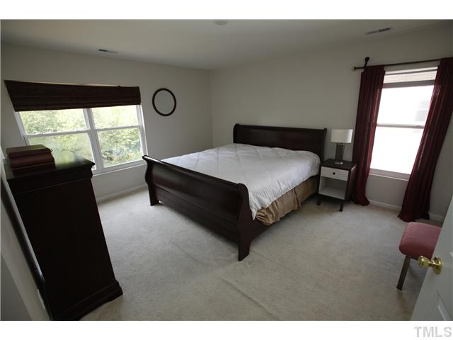 2605 Quarry Ridge Lane Raleigh, NC 27610 - Photo 7 of 8 a bed room with a bed window and mirror