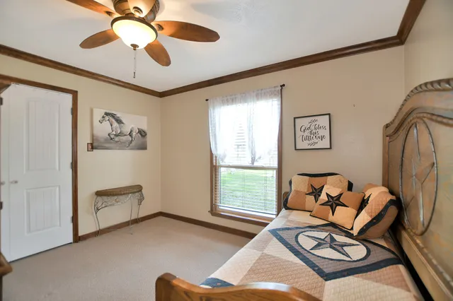 a bedroom with furniture and a flat screen tv