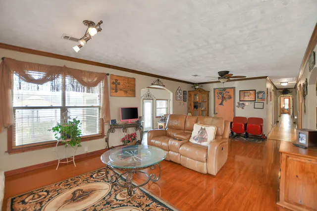 a living room with furniture large window and fireplace