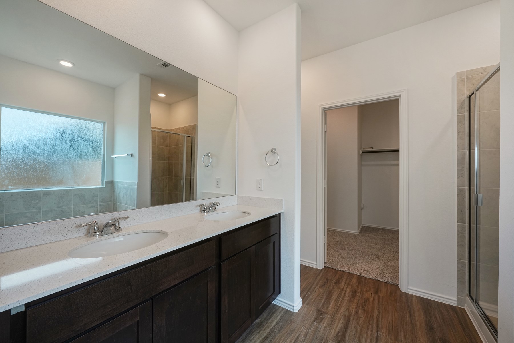 932 Mallow Road Leander, TX 78641 - Photo 16 of 34 Double vanity in this primary bathroom offers ample counter space and dual sinks.