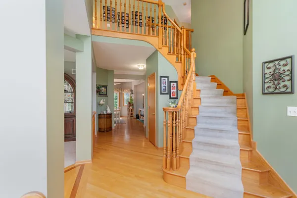a view of entryway and hall with wooden floor