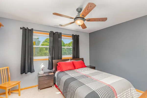 a bedroom with a bed and a chandelier