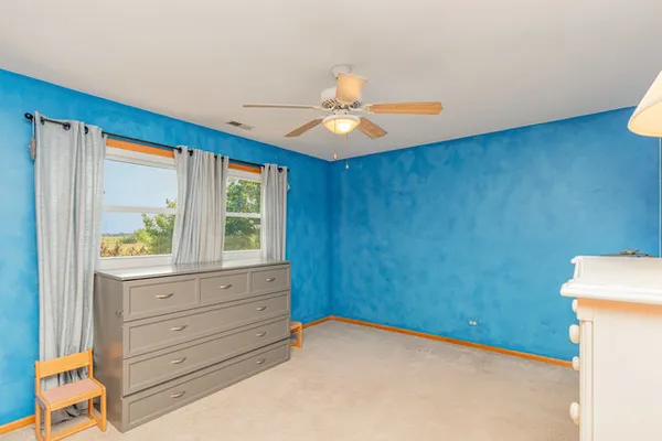 a view of room with a ceiling fan