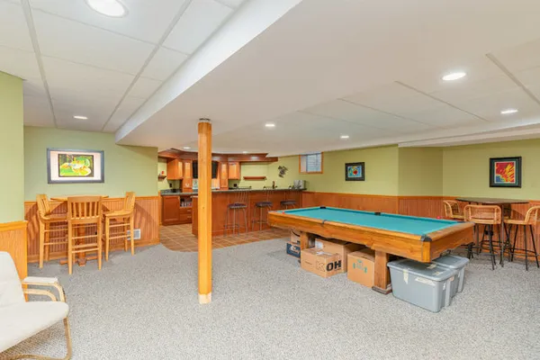 a room with furniture and pool table