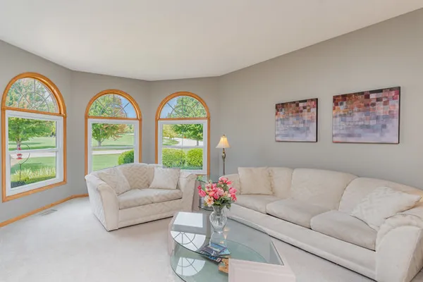 a living room with furniture and a large window