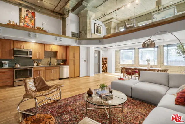 a room with lots of wooden furniture and large windows