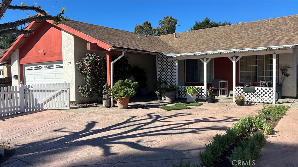 13254 Powers Court Poway, CA 92064 - Photo 2 of 11 a view of a house with wooden walls and potted plants
