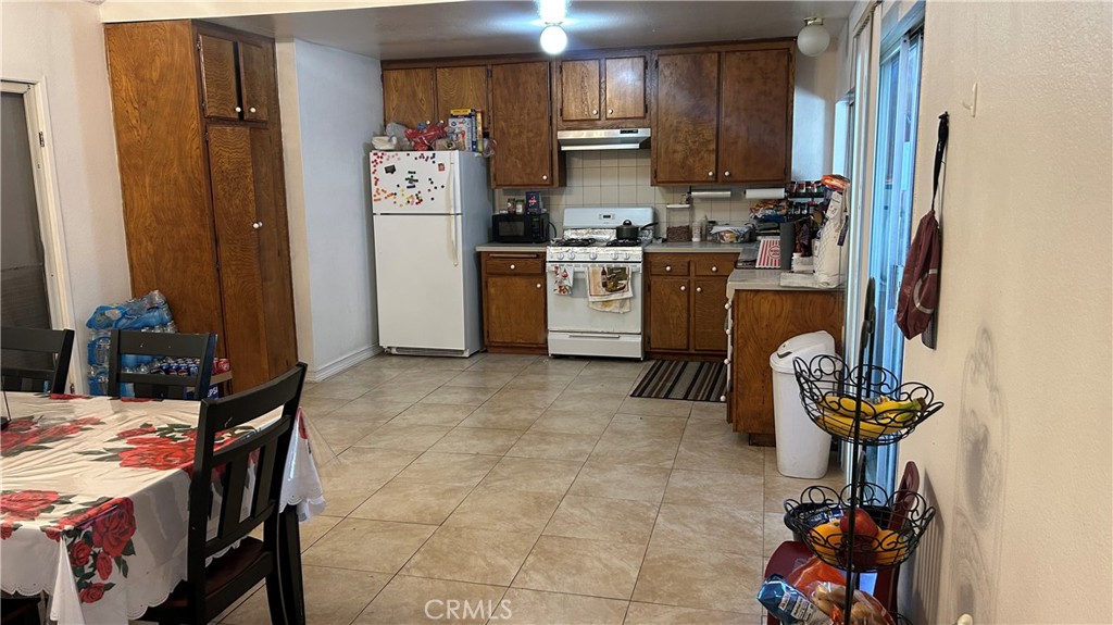 13254 Powers Court Poway, CA 92064 - Photo 4 of 11 a kitchen with stainless steel appliances granite countertop a stove refrigerator and a stove