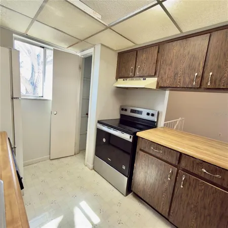 a kitchen with stainless steel appliances granite countertop a refrigerator and a stove