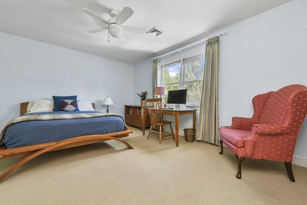 39 Brooks Road Lincoln, MA 01773 - Photo 18 of 40 a bed room with a bed and a chair