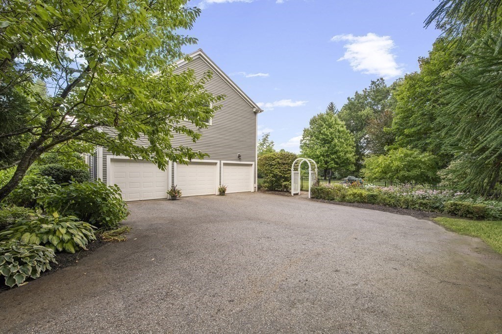 39 Brooks Road Lincoln, MA 01773 - Photo 26 of 40 a view of a house with a tree and plants