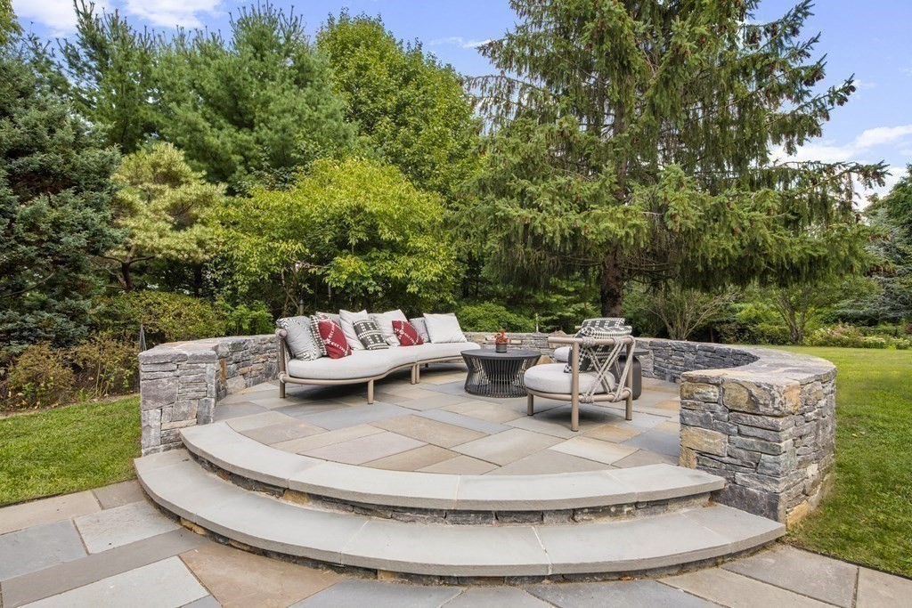 39 Brooks Road Lincoln, MA 01773 - Photo 27 of 40 a white bench sitting in the middle of a garden
