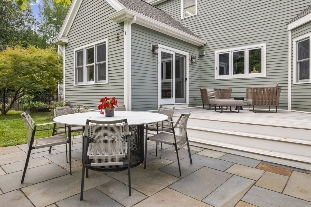 39 Brooks Road Lincoln, MA 01773 - Photo 29 of 40 a backyard of a house with table and chairs