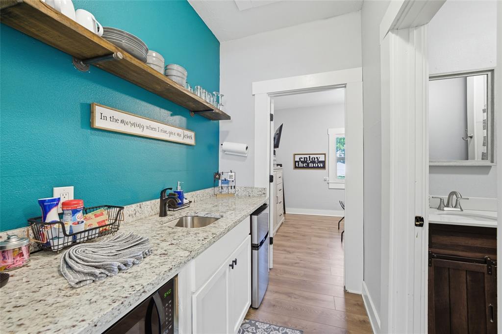 2320 Mistletoe Street Waco, TX 76706 - Photo 16 of 23 a bathroom with a granite countertop sink and a mirror
