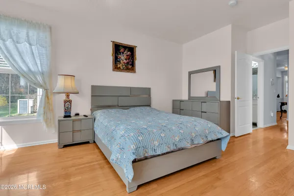 a bed sitting in a bedroom next to a window