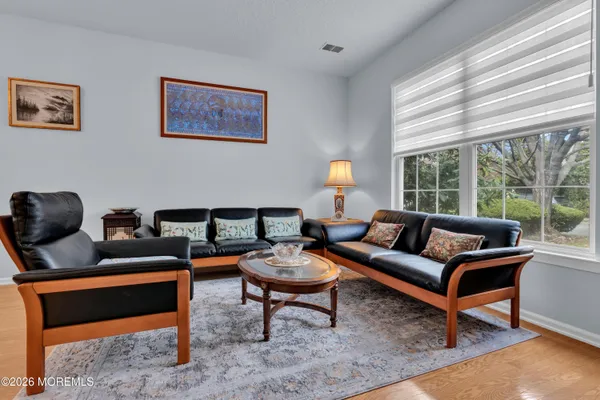 a view of a dining room with furniture window and wooden floor