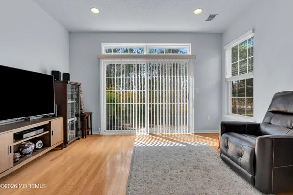 a view of a hallway with wooden floor and furniture