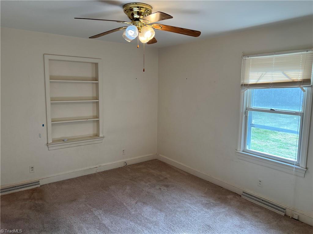 2183 Rowe Road Lexington, NC 27295 - Photo 15 of 42 Bedroom 2 with ceiling fan and built in shelf.