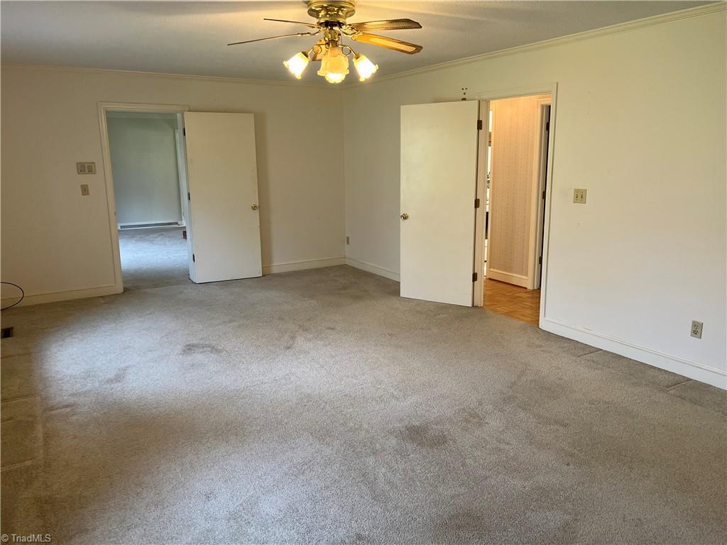 2183 Rowe Road Lexington, NC 27295 - Photo 26 of 42 Large primary bedroom suite with walk-in closet and bathroom across the hall.