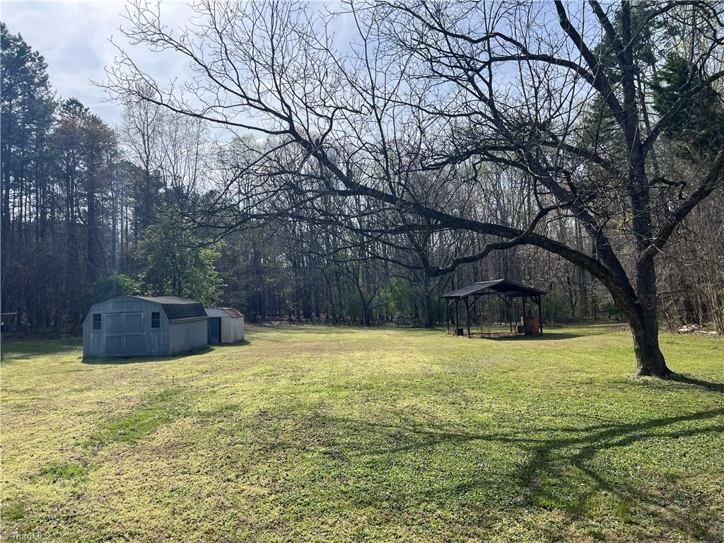 2183 Rowe Road Lexington, NC 27295 - Photo 38 of 42 Awesome, level backyard with two storage sheds and another large covered open air shed.