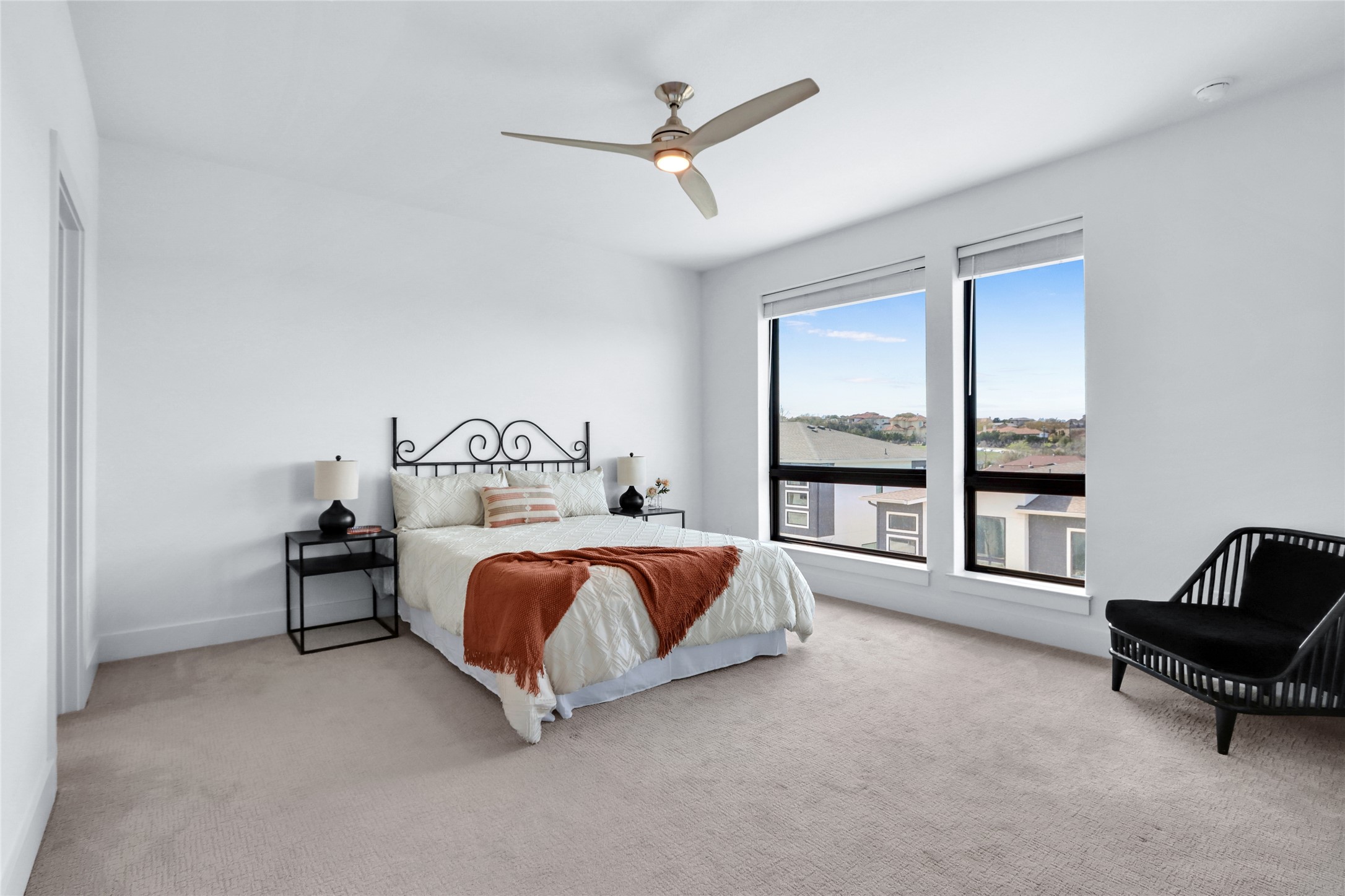 2050 Lohmans Spur Road, Unit 501 Lakeway, TX 78738 - Photo 16 of 40 a spacious bedroom with a bed a couch and a window
