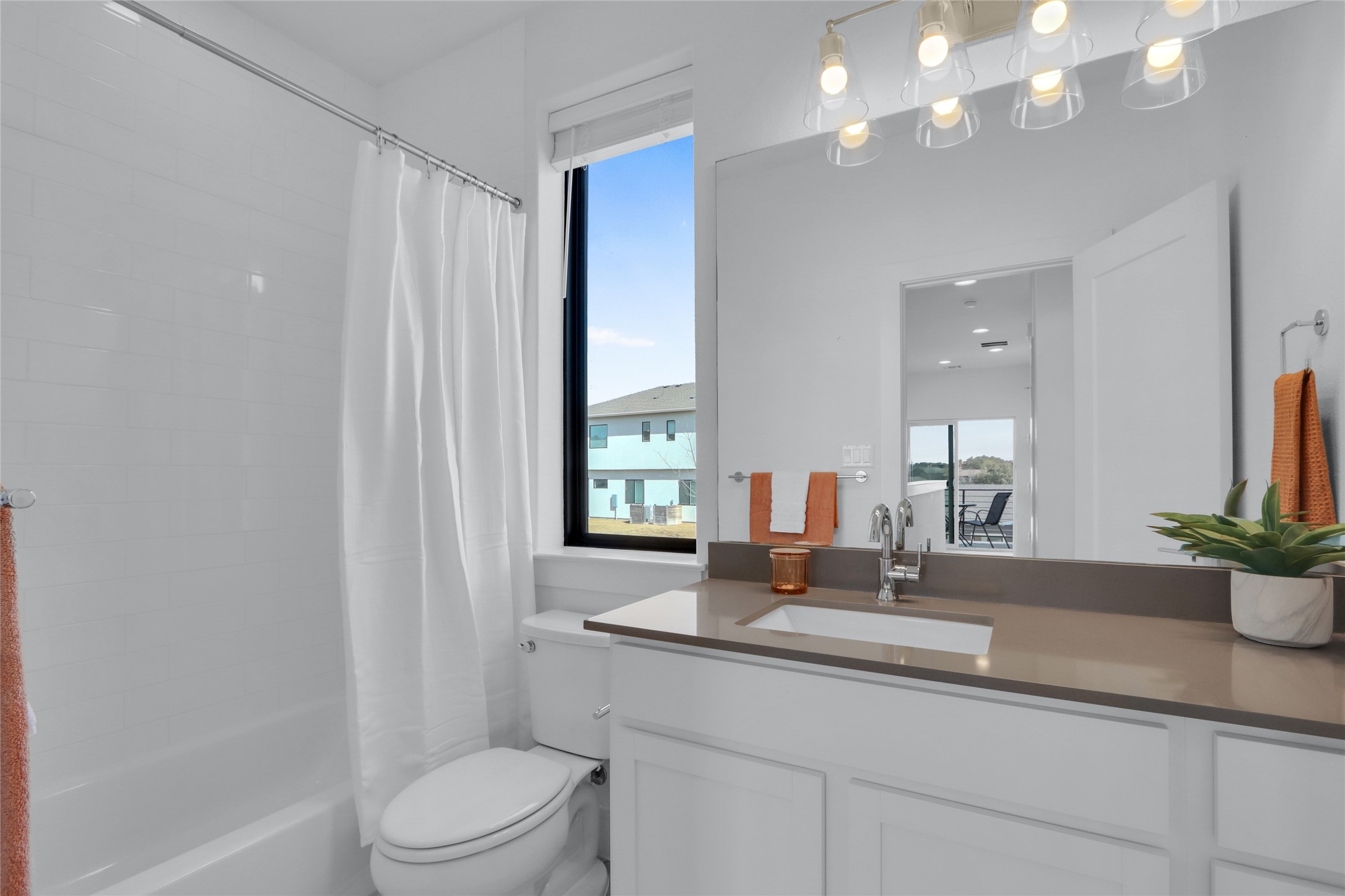 2050 Lohmans Spur Road, Unit 501 Lakeway, TX 78738 - Photo 23 of 40 a bathroom with a double vanity sink toilet and a mirror