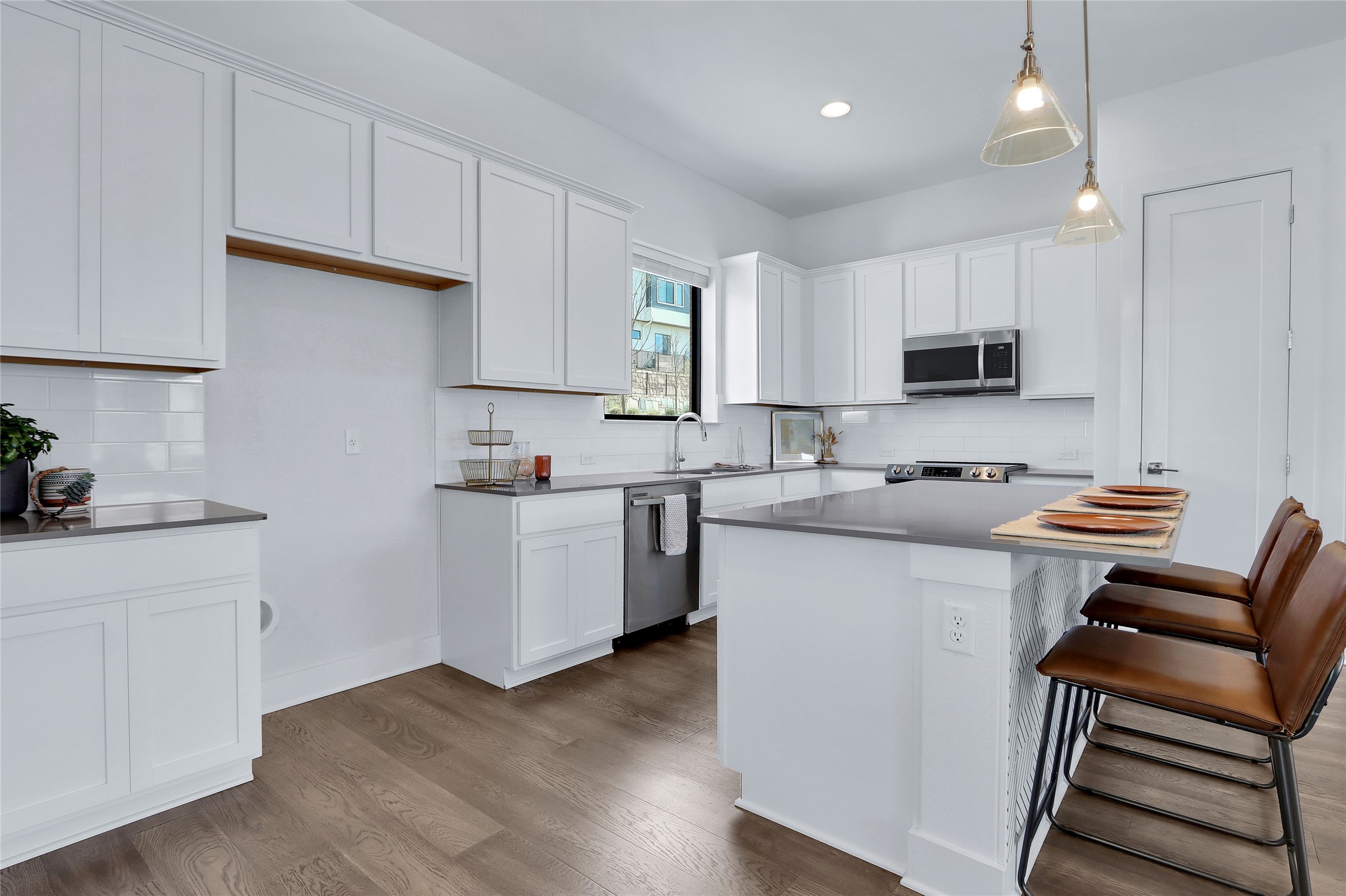 2050 Lohmans Spur Road, Unit 501 Lakeway, TX 78738 - Photo 3 of 40 a kitchen with a sink cabinets and wooden floor