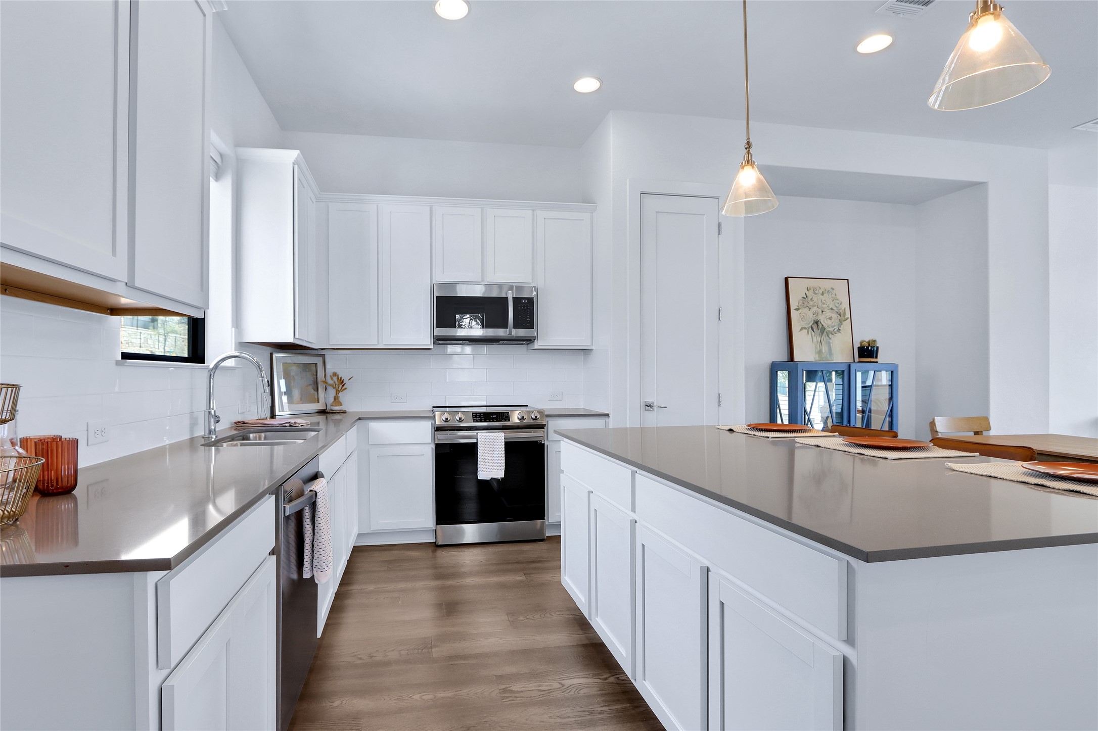 2050 Lohmans Spur Road, Unit 501 Lakeway, TX 78738 - Photo 7 of 40 a kitchen with stainless steel appliances granite countertop a sink stove and refrigerator