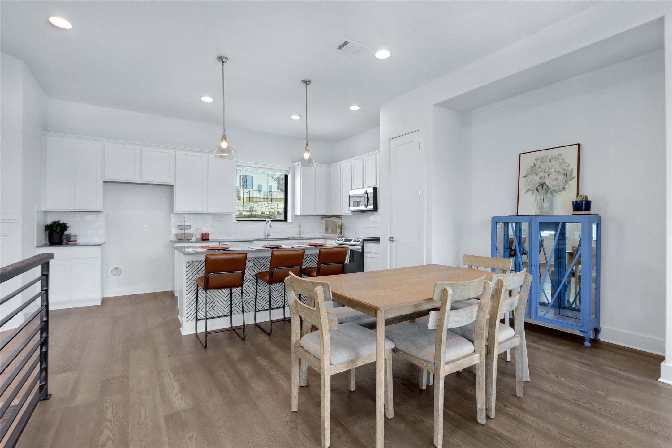 2050 Lohmans Spur Road, Unit 501 Lakeway, TX 78738 - Photo 9 of 40 a kitchen with stainless steel appliances a dining table chairs and wooden floor
