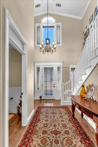 a living room with fireplace furniture and a large window