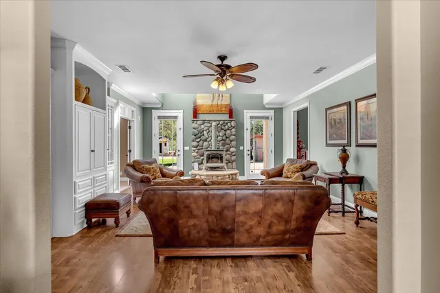 a living room with furniture ceiling fan and a rug