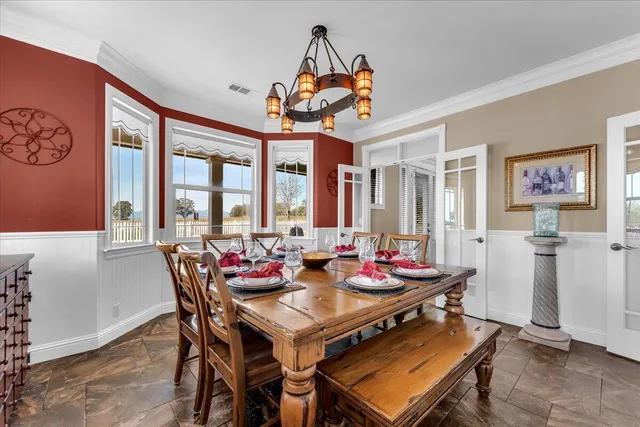 a view of a livingroom with a ceiling fan and windows