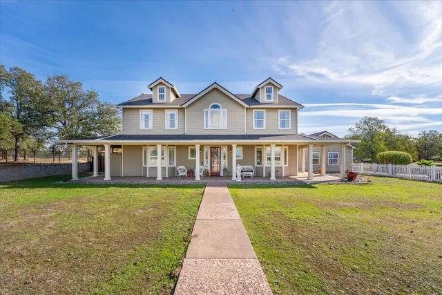 a view of a house with backyard sitting area and garden