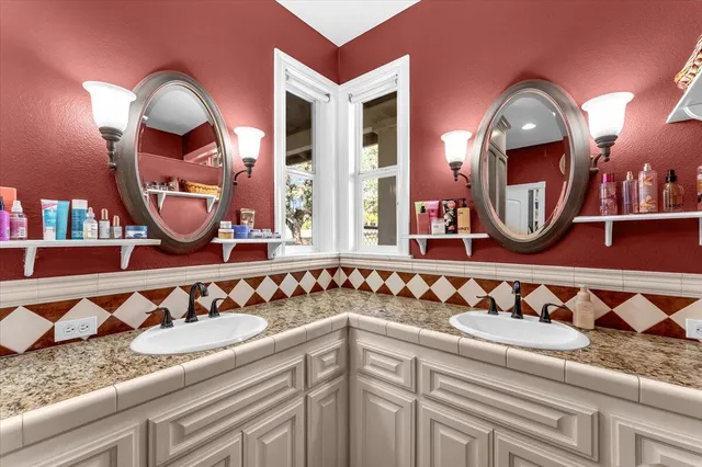 a view of a house with a big yard and large trees